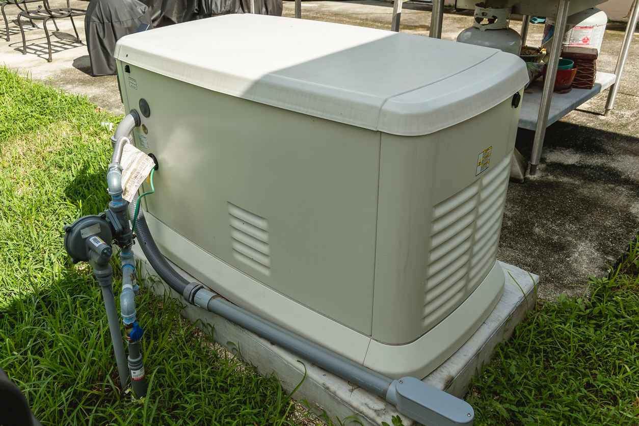 A Home Standby Generator installed at the backyard of a house.